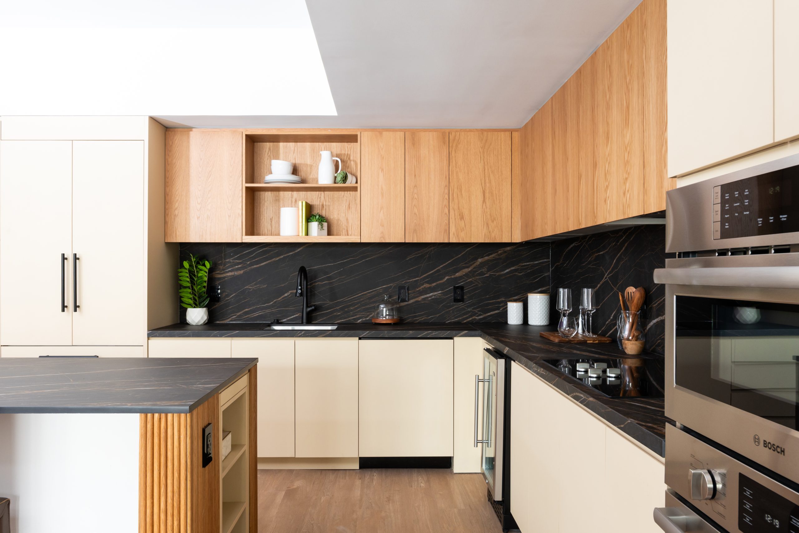Accolade penthouse kitchen with premium finishes, top of the line appliances including a wine fridge, custom cabinety and quartz counters and backsplash.